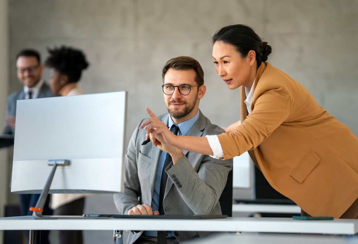 Man and woman working at a computer in an office.