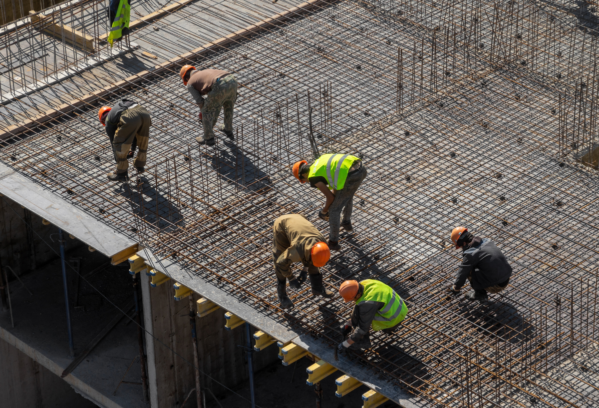 Construction workers on rebar scaffolding.