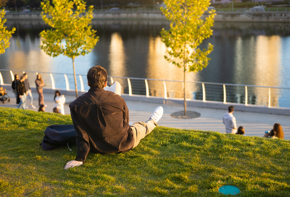 man enjoying outdoors while sitting on grass