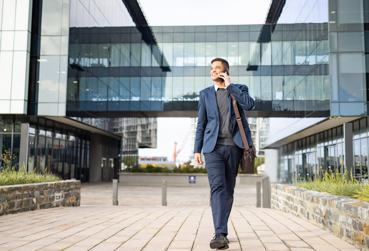 Man in a suit walking outside talking on phone