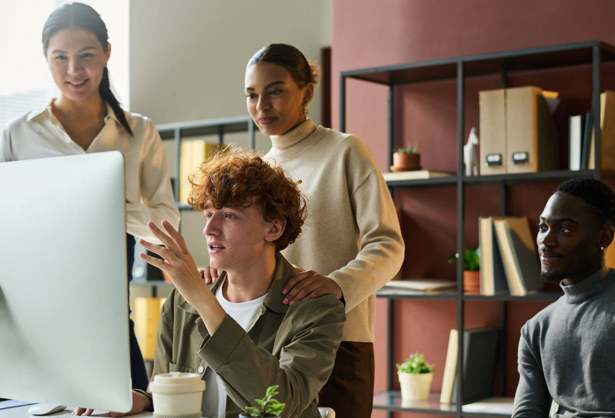 working on a project together looking at a large monitor