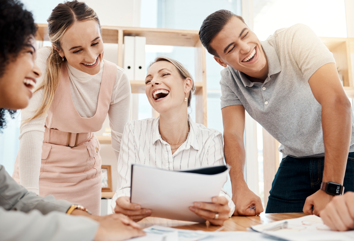 Group of professionals in an office meeting, smiling.