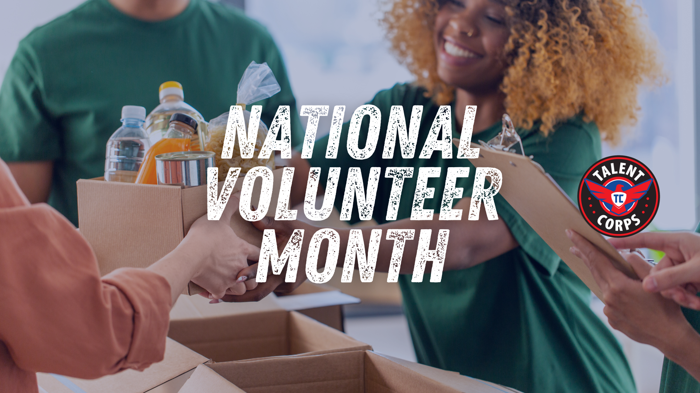 Woman volunteer in green tee shirt at a food bank cardboard box of food supplies - Words National Volunteer Month and Talent Corps logo on picture
