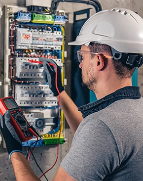 Worker in a hard hat and safety glasses.