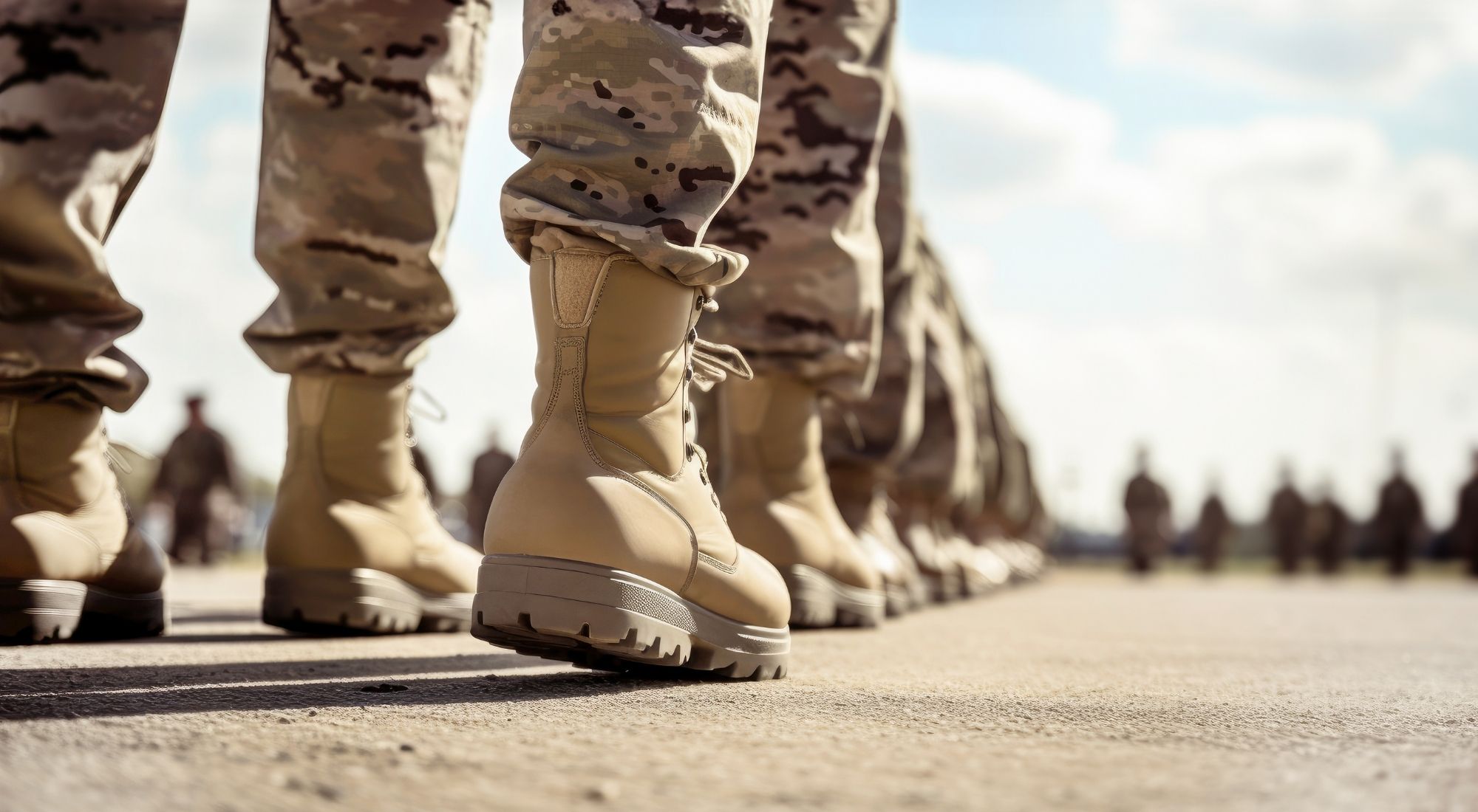 Close-up of military boots on the ground.